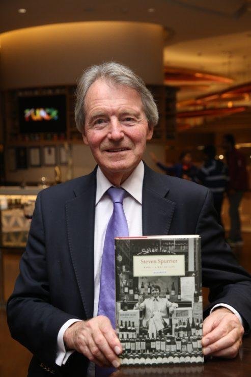 Steven Spurrier with a book